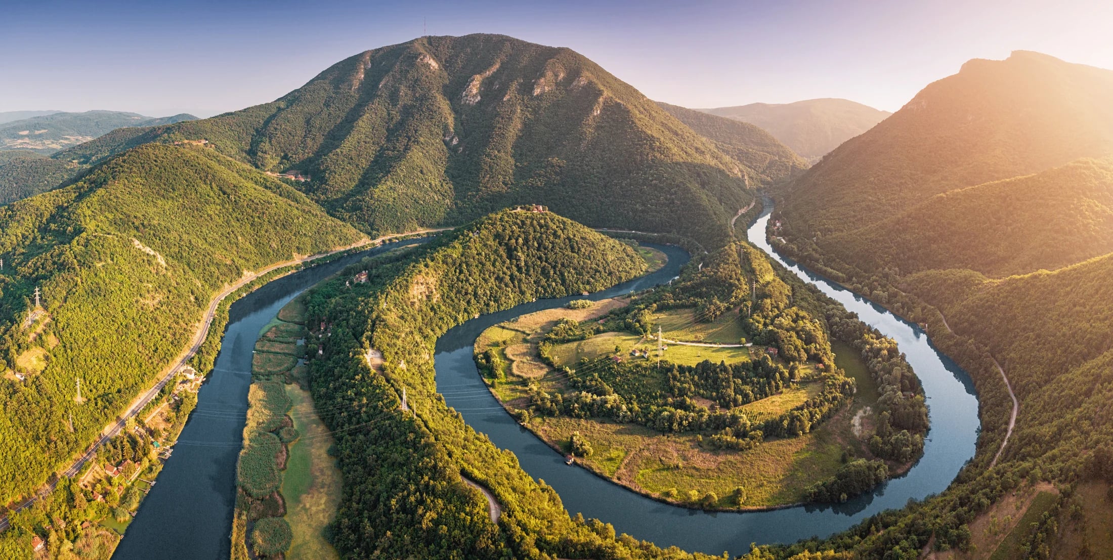 Aerial view of a river winding through the mountains of Serbia and Bosnia